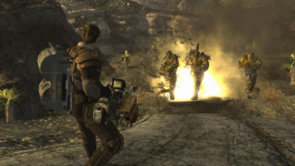 The player character firing at Great Khan raiders amid an explosion in the desert