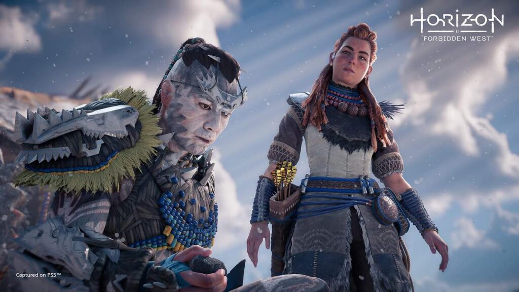 Aloy standing beside a tribal elder in a snowy mountain setting