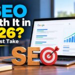 Is SEO worth it in 2026? Laptop showing Google search results and a rising growth chart, with wooden SEO letters and a target on a desk.